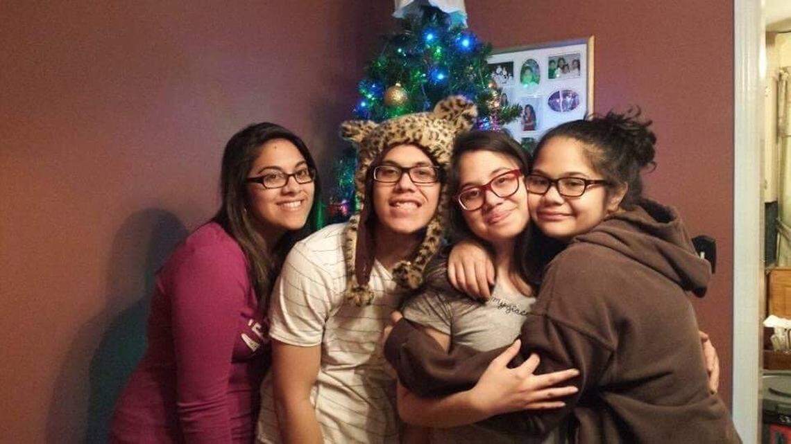 Senior Airman Lawrence Manlapit III with his three sisters, from left, Shayla, Davian and Kaiya. This photo was taken just before Christmas in 2013.