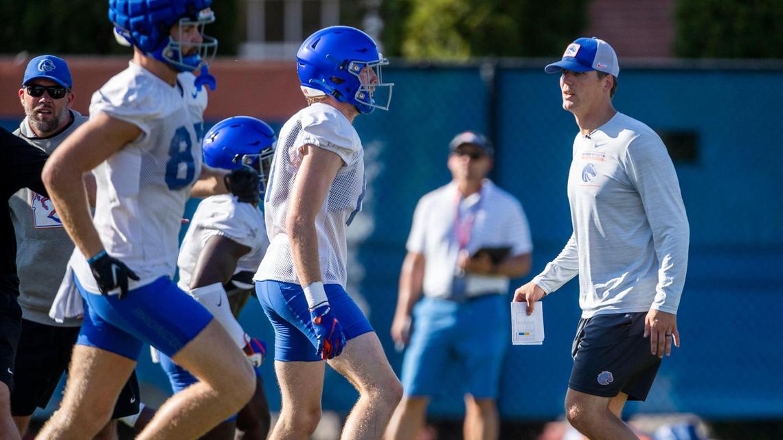 Boise State wide receivers coach Matt Miller runs players through a drill during fall camp in August.