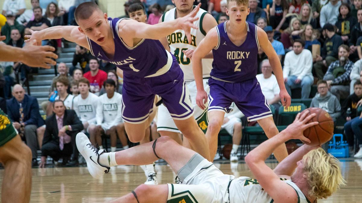 Borah forward Austin Bolt looks to pass around Rocky Mountain’s Jaden Hansen after a loose-ball scramble Friday at Borah High. Rocky Mountain prevailed 62-58.