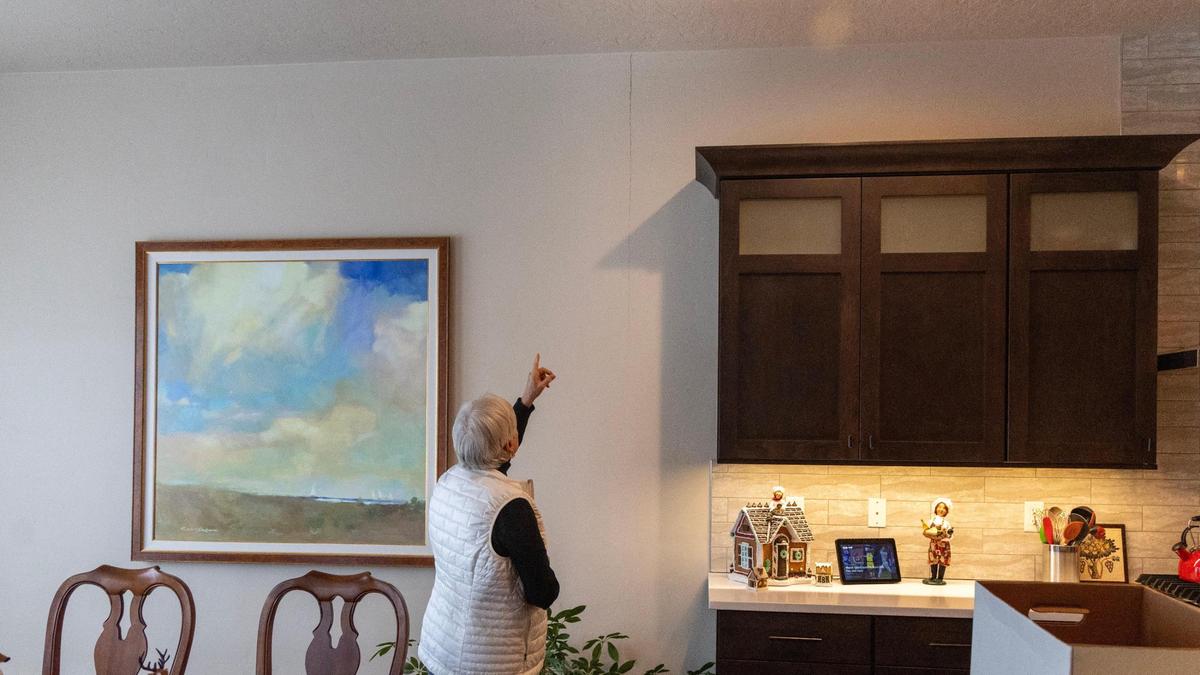 Judy Myers points to a large crack on her kitchen wall.