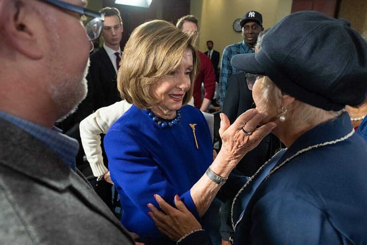 US Representative and former Speaker of the House Nancy Pelosi, Democrat of California, embraces Pamela Hemphill (R), a former supporter of US President Donald Trump who participated in the attacks on the US Capitol on January 6, 2021 and later refused a presidential pardon from Trump, during a hearing by House Democrats on the fifth anniversary of the attacks, on Capitol Hill, in Washington, DC, January 6, 2026. (Photo by SAUL LOEB / AFP via Getty Images)