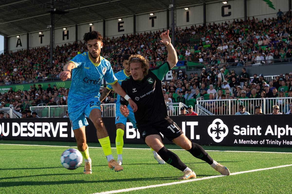 AC Boise midfielder Nick Moon, right, battles Union Omaha defender Younes Boudadi for the ball Saturday.