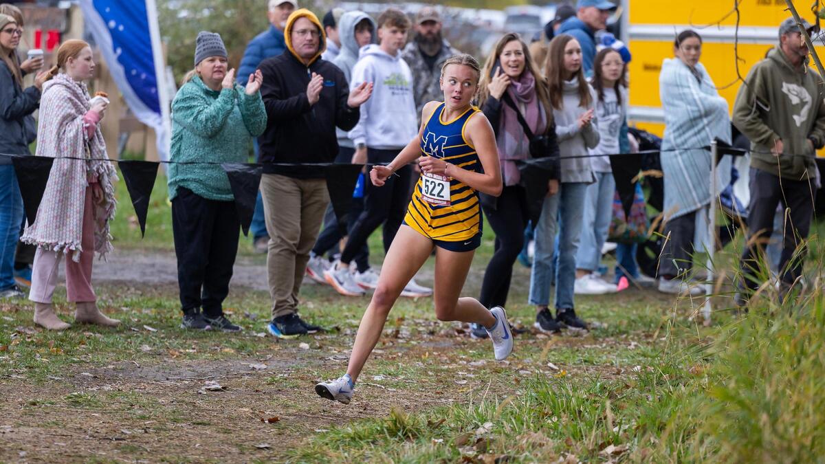 Meridian High School’s Paisley Taylor takes a corner en route to the 6A girls individual title at the state cross country meet Saturday at Eagle Island State Park.