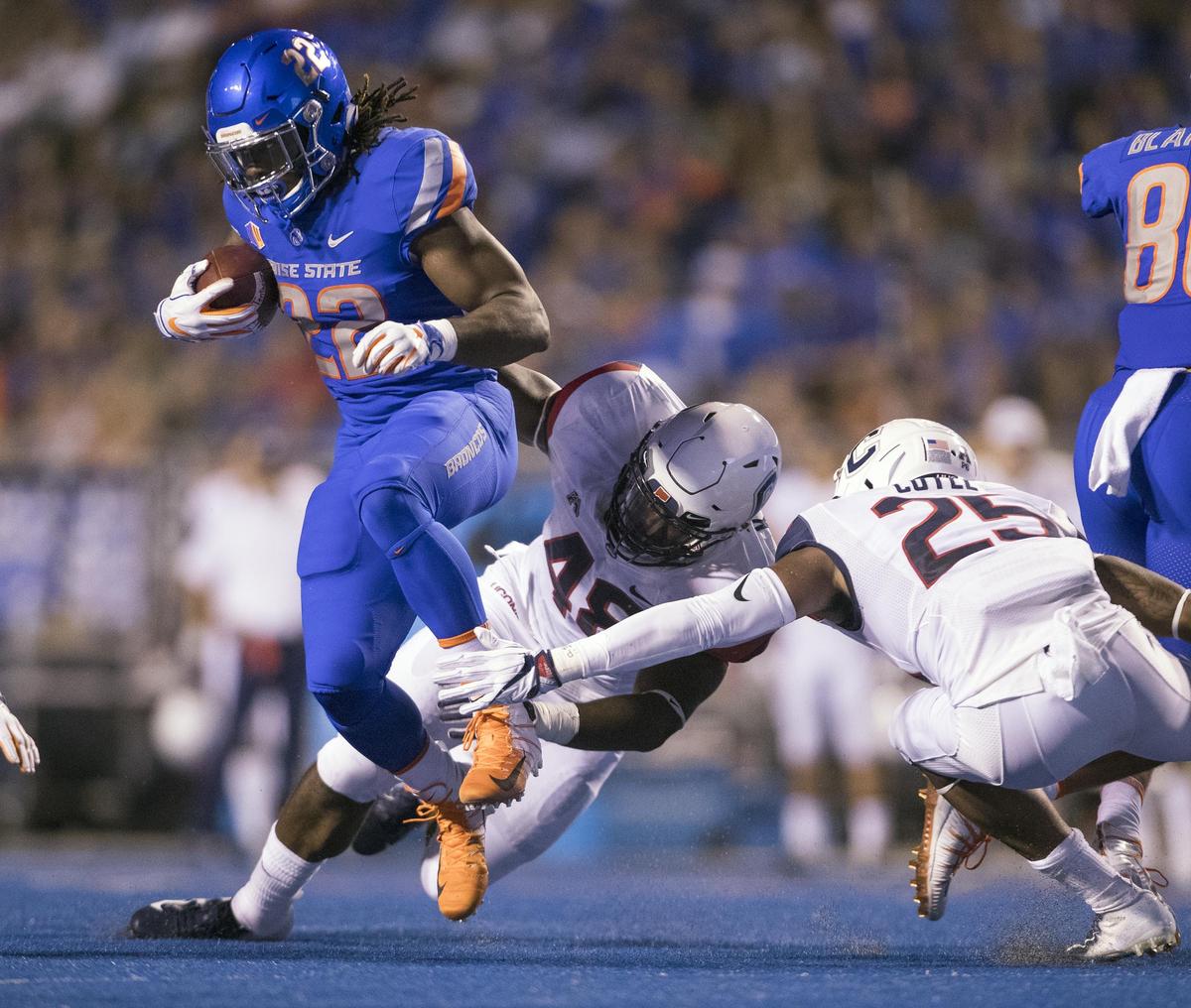 Boise State running back Alexander Mattison (22) spins out of a tackle attempt by Connecticut linebacker Kevon Jones (48) and defensive back Tyler Coyle (25) in the Broncos’ home opener Saturday, Sept. 8, 2018 at Albertsons Stadium in Boise.
