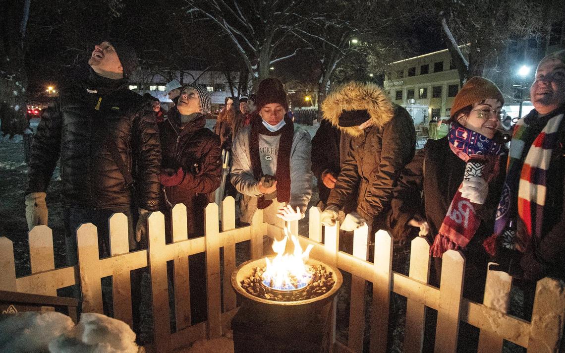 Attendees of the Idaho Potato Drop stand around one of 30 fire pits as temperatures dropped to as low as 10 degrees on New Year’s Eve in Boise. After going virtual in 2020, the New Year’s Eve event returned as an in-person celebration Friday, Dec. 31, 2021, in front of the Idaho State Capitol.
