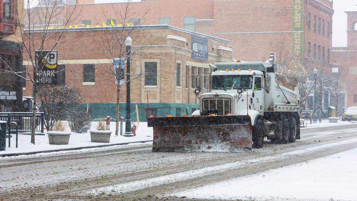 An Ada County Highway District plow clears snow along W. Idaho St. in downtown Boise in December 2021. Our salary database shows how much employees of the road agency make.