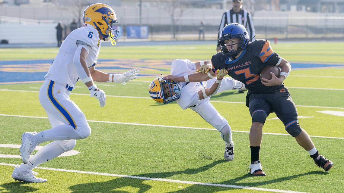 Tri-Valley senior quarterback Jace Waggoner gets past Carey freshman Tayton Sears during the 3A state football championship game, Saturday, Nov. 22, 2025 at Middleton High School.