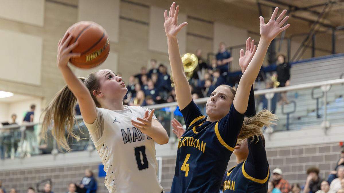 Mountain View sophomore Brooklyn Clausen looks to shoot past Meridian senior Olivia Fluckiger during their 6A District Three girls basketball tournament play-in game, Tuesday, Feb. 3, 2026.