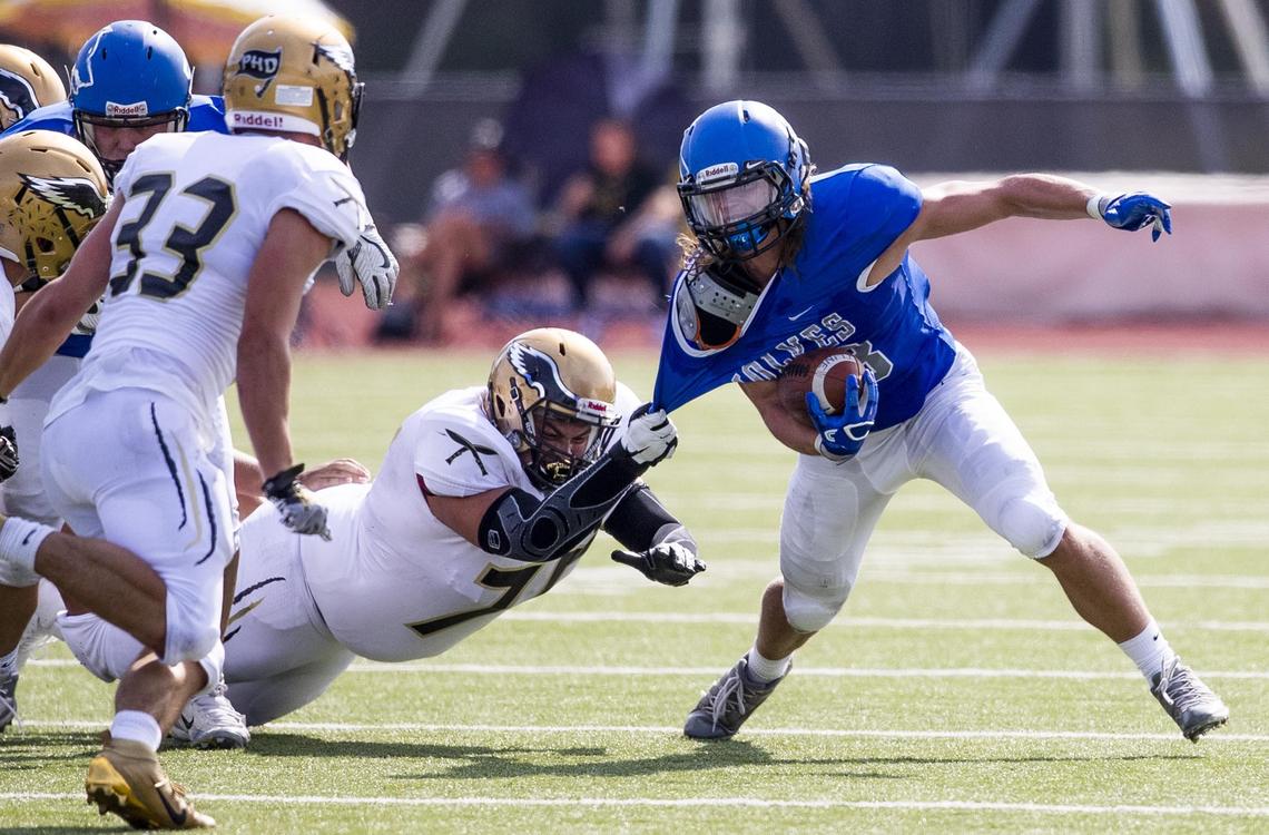 Capital defensive lineman Moses Estrada prevents Timberline running back Kyle Adams from breaking away in a 5A SIC game Saturday, Sept. 7, 2019 at Dona Larsen Park in Boise.