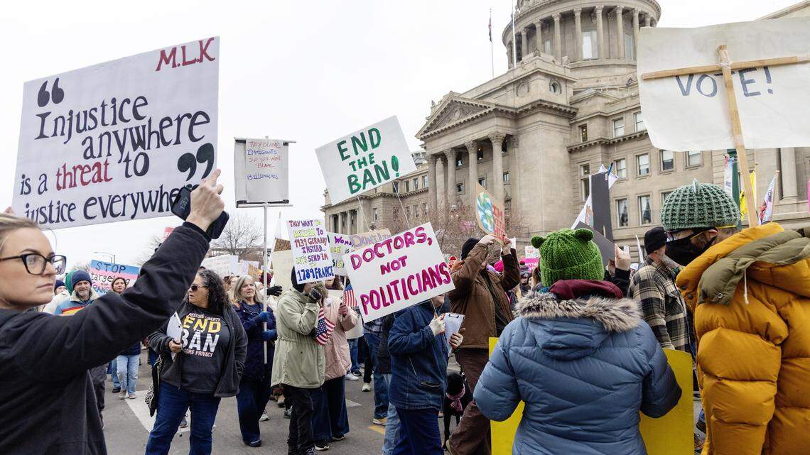 People hold signs outside the Idaho Capitol during the annual Women's March on Saturday, Jan. 17, 2026. The event touched on topics including women's education, reproductive rights and LGBTQ+ rights. It was organized by Women of Idaho, a grassroots organization focused on improving the quality of life for women and girls in Idaho.