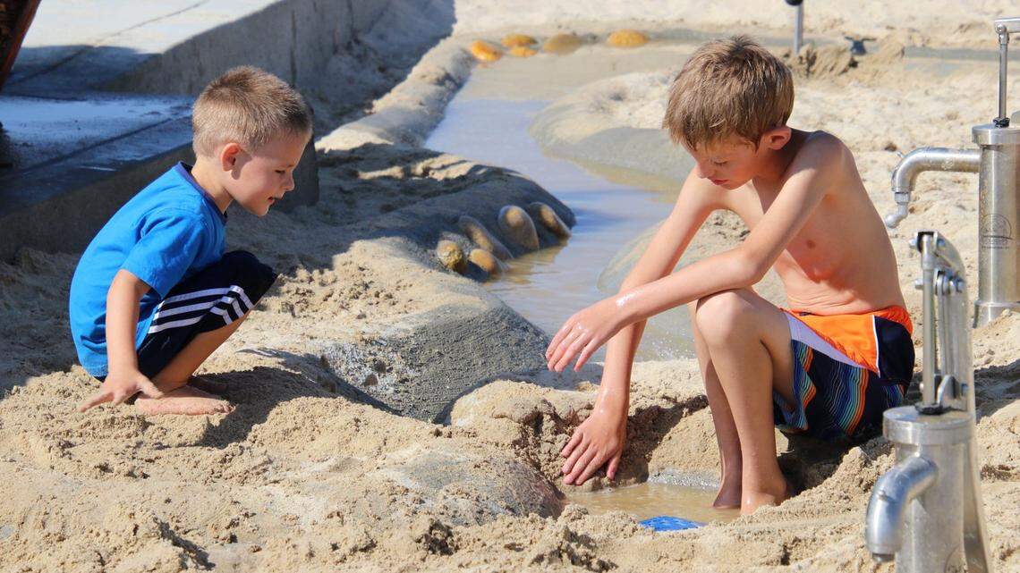 Children play in the sand and water area at Meridian’s Discovery Park.