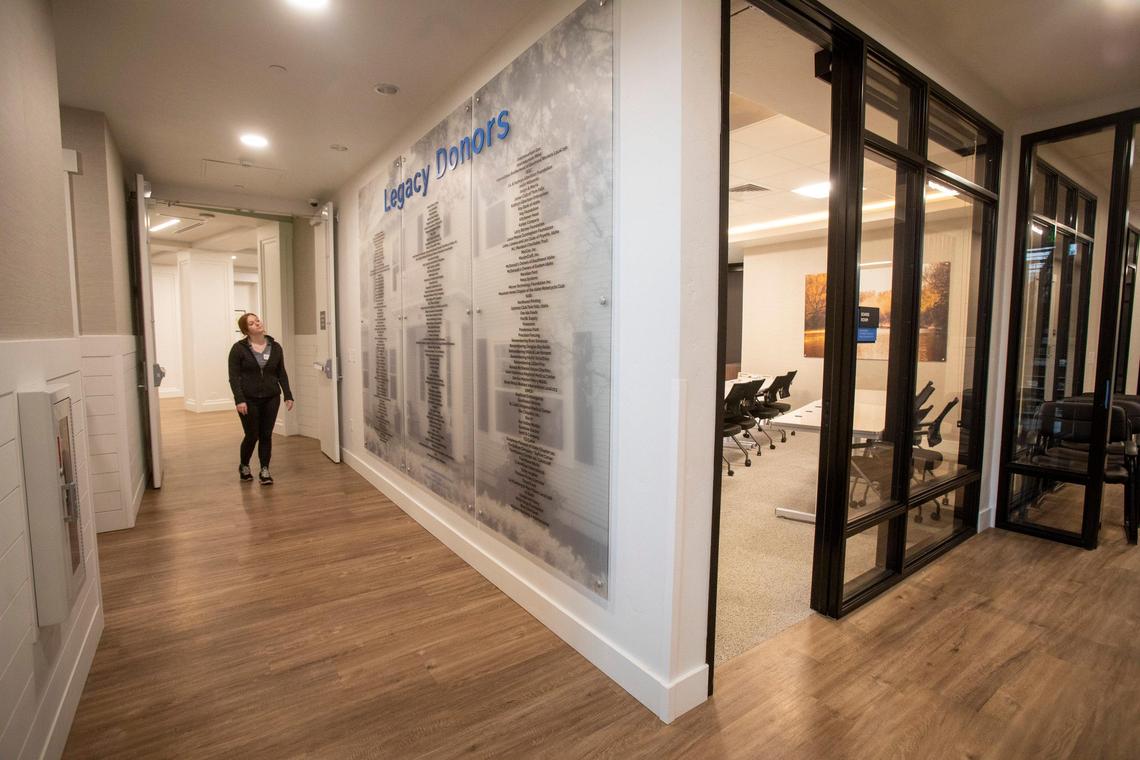 The new Ronald McDonald House includes a wall of names, which includes donors from 32 years ago, at the first Ronald McDonald House, up to the present. The new house includes room for meetings, at right.