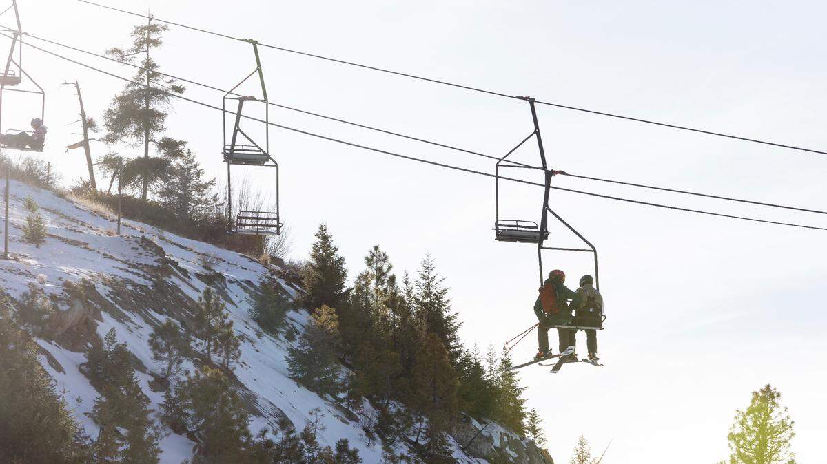 Skiers ride a chair lift at Bogus Basin last year on Nov. 27.
