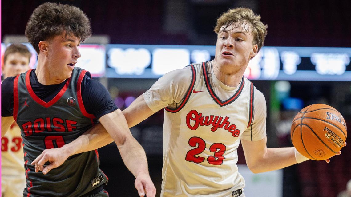 Owyhee senior Boden Howell controls the ball as Boise junior Eli Rich defends during the 6A District Three boys basketball tournament championship game Friday at Idaho Central Arena in Boise.