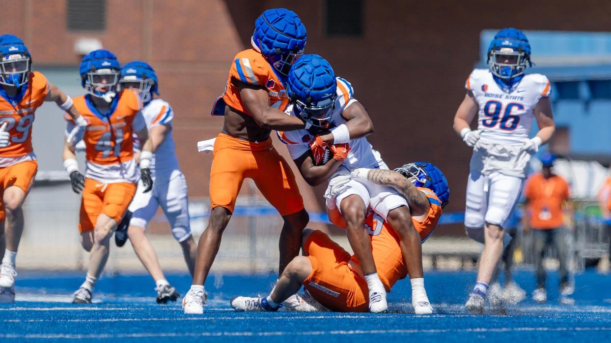 Boise State University running back Jambres Dubar is brought down by linebackers Udoka Ezeani, left, and Gavin Hambrick, right, during their spring football game, Saturday, April 20, 2024 at Albertsons Stadium.