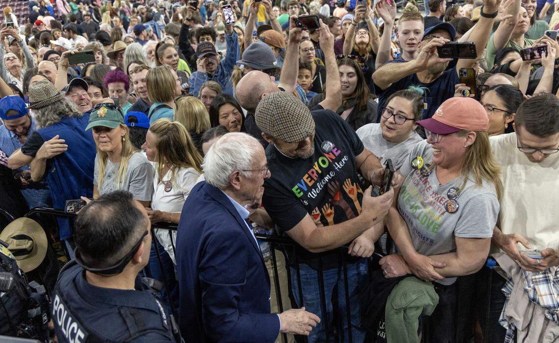 U.S. Sen. Bernie Sanders interacts with members of the crowd and poses for selfies after speaking Monday night.