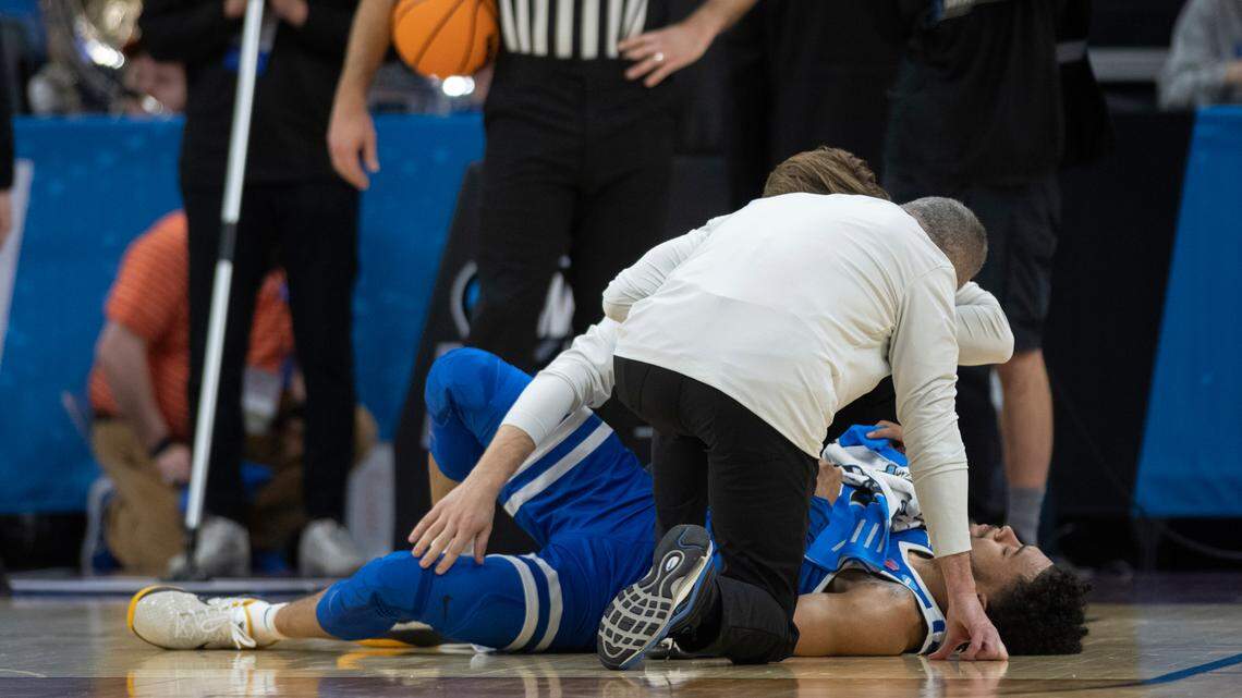 Boise State guard Marcus Shaver Jr. is looked over after being injured in the first half of the Broncos’ 75-67 loss to Northwestern in the first round of the NCAA Tournament on Thursday at the Golden 1 Center in Sacramento, California.