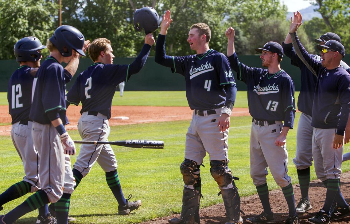 Teammates welcome Mountain View senior Carson Smith back to the dugout after the Mavericks scored six runs in the 5th inning againt Eagle. Mountain View won the semifinal game in the state 5A baseball tournament 9-2 Saturday, May 18, 2019 at Memorial Stadium in Boise.