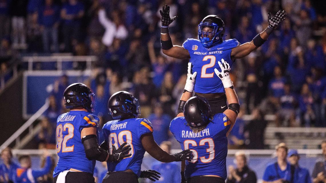 Boise State running back Ashton Jeanty is lifted up by teammate Boise State offensive lineman Mason Randolph after Jeanty’s touchdown in the fourth quarter of their game against Fresno State at Albertsons Stadium on Saturday, Oct. 8, 2022. The Broncos 40-20.