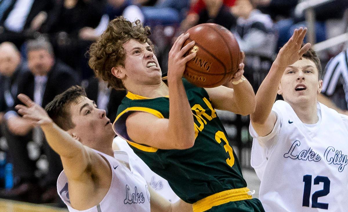 Borah junior Luke Hoetker scores after a hard foul on play defended by Lake City’s Seth Hanson (12) and Brayden Sundstrom in the first round of the 5A state boys basketball tournament Thursday, March 5, 2020 at Ford Idaho Center in Nampa.