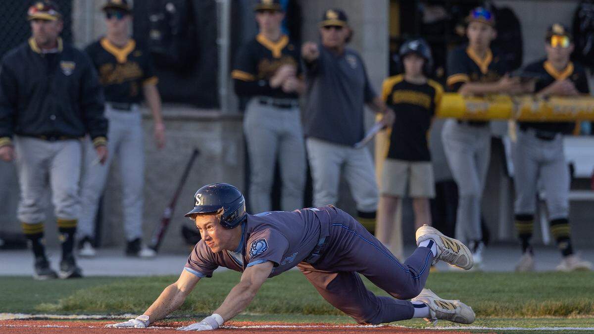 Skyview junior Aaron Vavold slides to home plate on a three-run homer in the second inning of their game against Bishop Kelly in the 5A District Three baseball championship game held at Bishop Kelly, Thursday, April 30, 2026. 