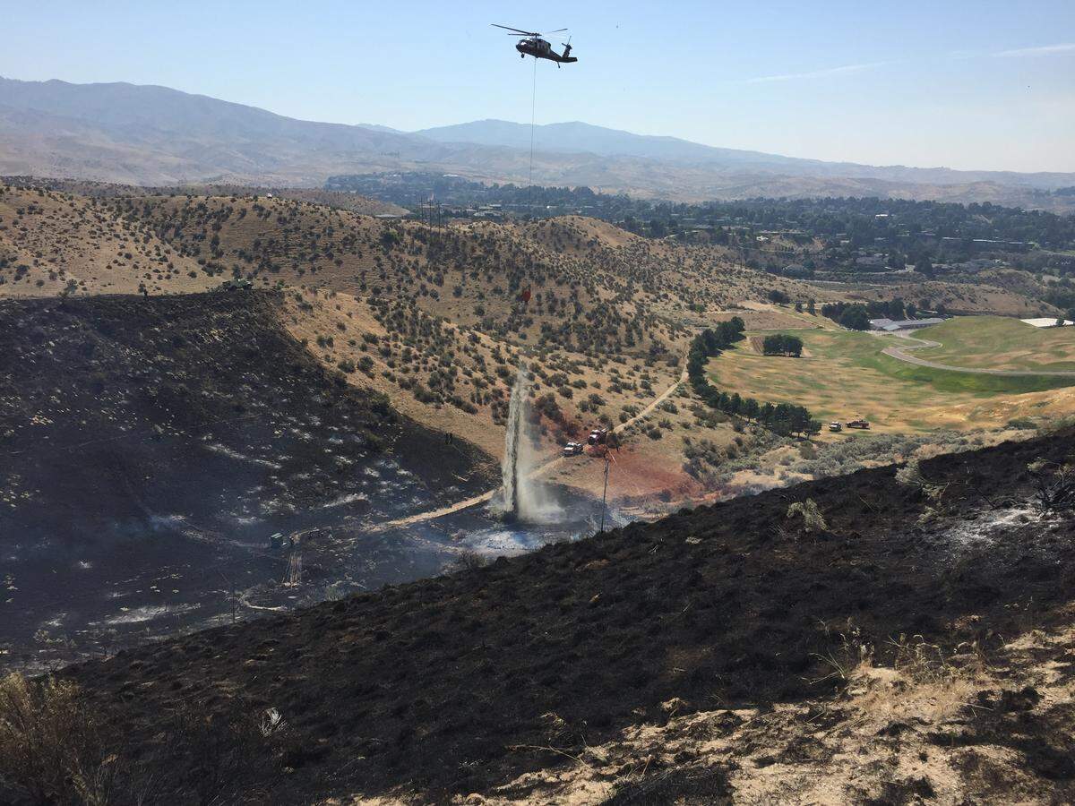 Becker Ridge Lane and helicopters helped contain the grass fire in the Boise Foothills on Friday.