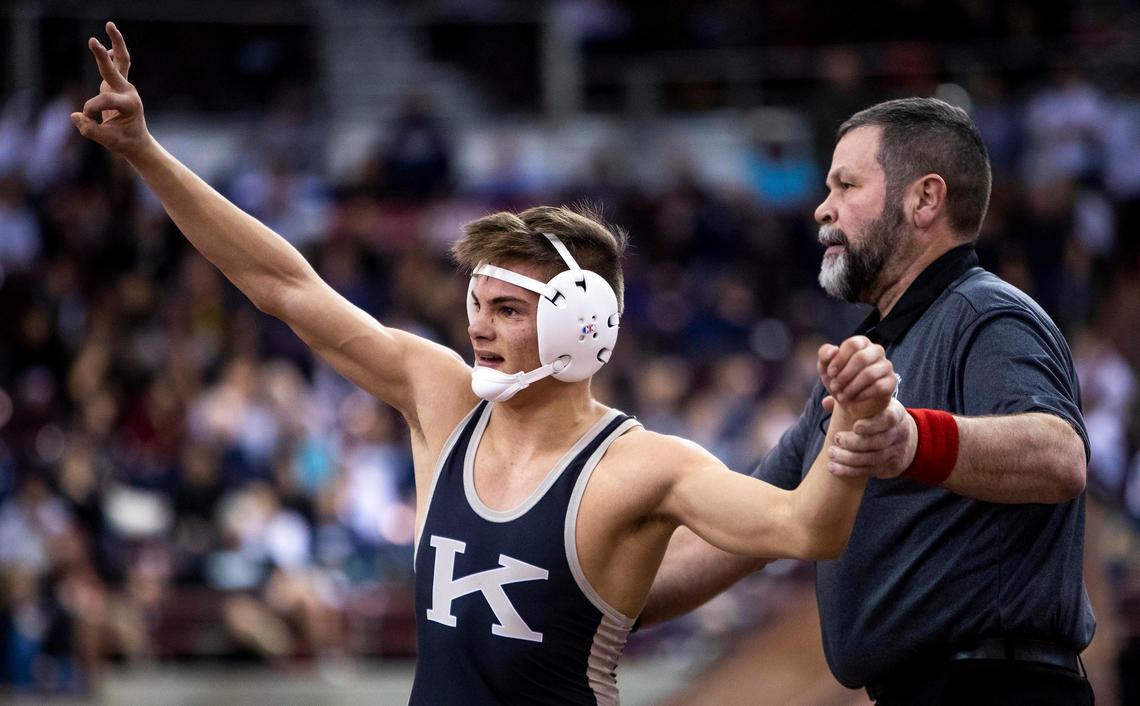 Kuna’s Hunter Mitchell holds up three fingers for his three state titles after winning the 4A 120-pound state championship Saturday, Feb. 29, 2020 at Ford Idaho Center in Nampa.