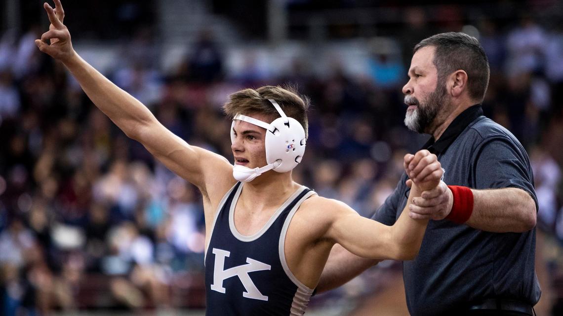 Kuna’s Hunter Mitchell holds up three fingers after winning his third state title last year. He’ll try to join the exclusive four-time state champion club Friday.