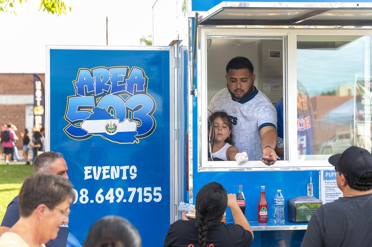 Carlos Siguenza takes an order for pupusas with help from his daughter Brielle, 7, at the family’s new food truck at the inaugural Viva Nampa Festival at Lloyd Square Park in downtown Nampa, Friday, June 27, 2025. The event was a collaboration between the 208 Night Market and the Downtown Nampa Association.