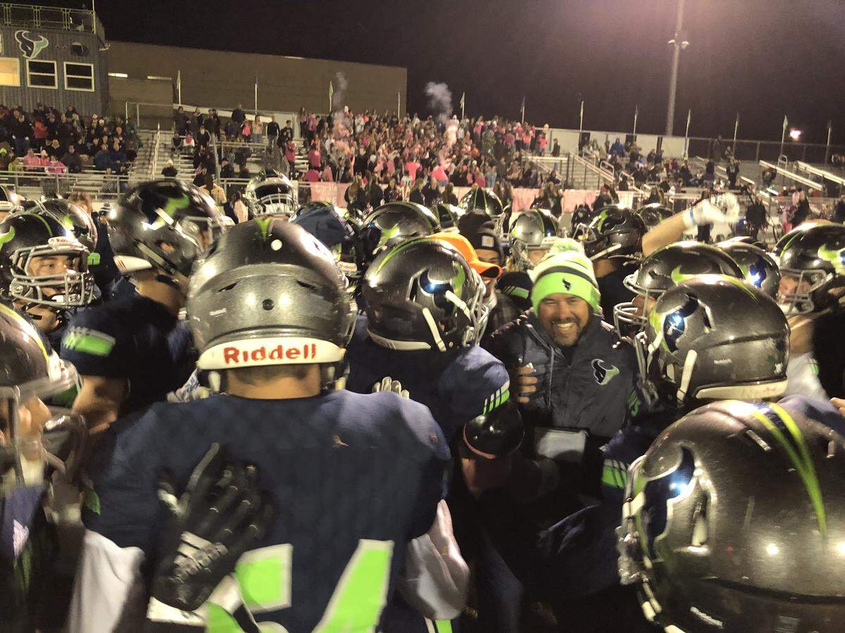 The Mountain View football team congratulates Mavericks coach Judd Benedick after he won his 100th career game last week.