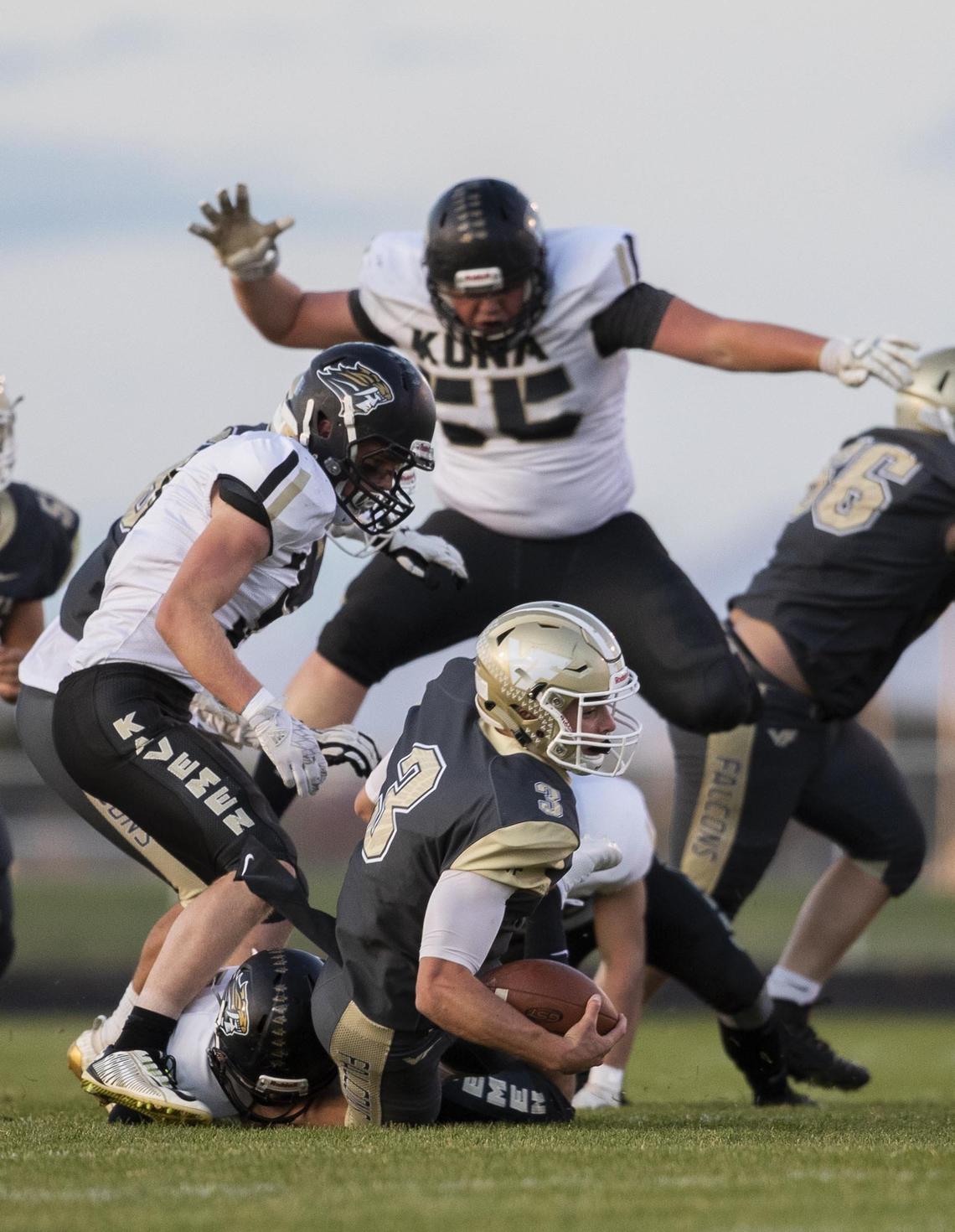 Vallivue quarterback Lan Larison is knocked down in the backfield on a rush by Kuna’s defense Friday, Oct. 4, 2019 at Vallivue High School in Caldwell.