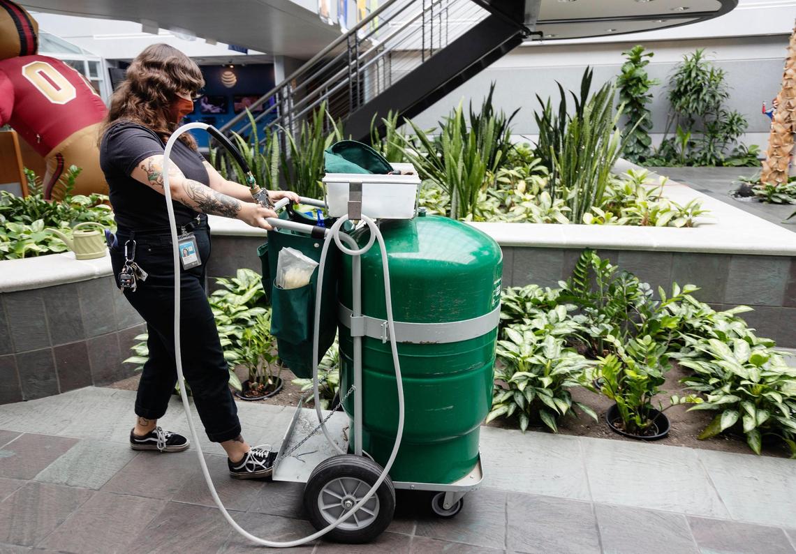 Natalie Whiting takes care of plants inside the AT&T call center on Meeker Avenue, one of The Potting Shed’s biggest clients.
