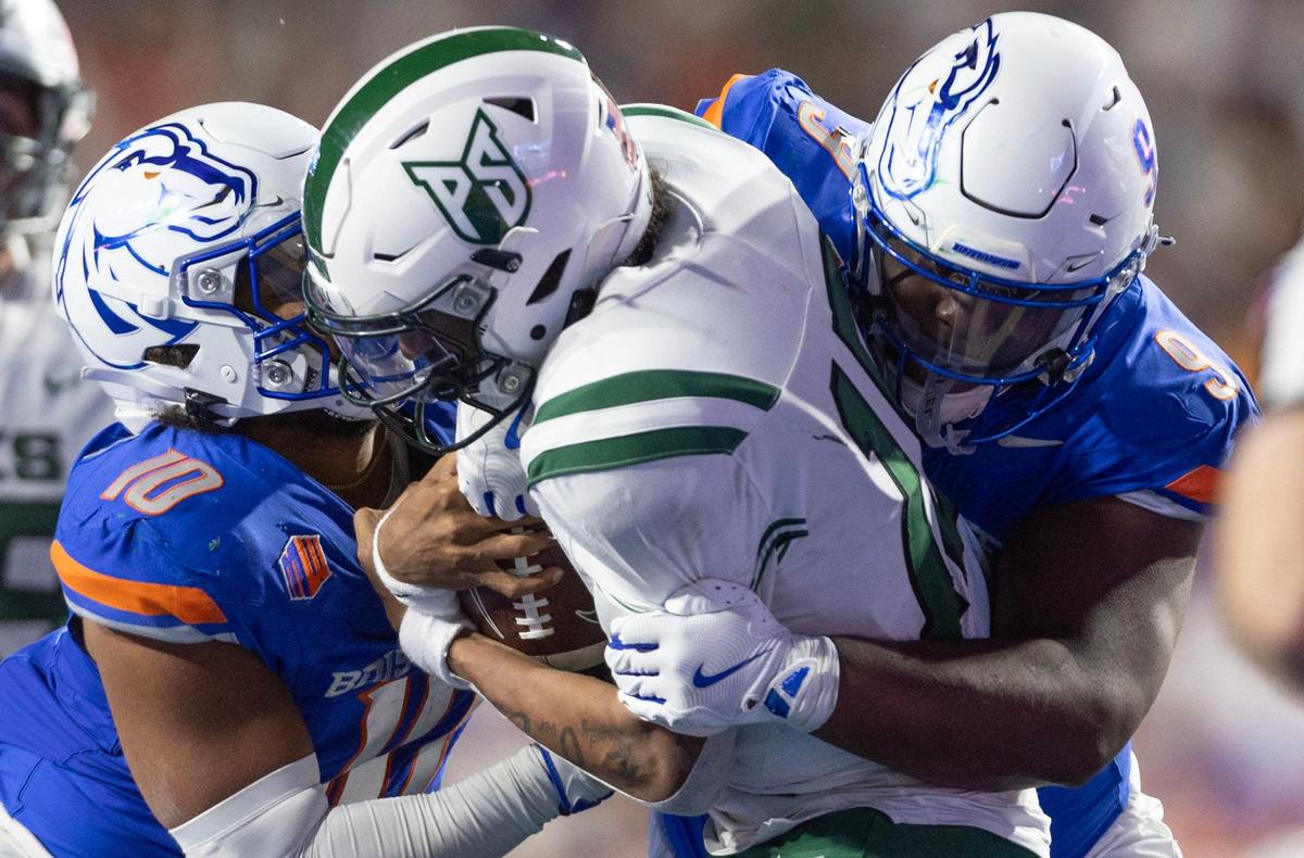 Boise State nose tackle Shelddon Newton and linebacker Andrew Simpson sack Portland State quarterback Dante Chachere in the Broncos’ homeopener at Albertsons Stadium in Boise, Saturday, Sept. 21, 2024.