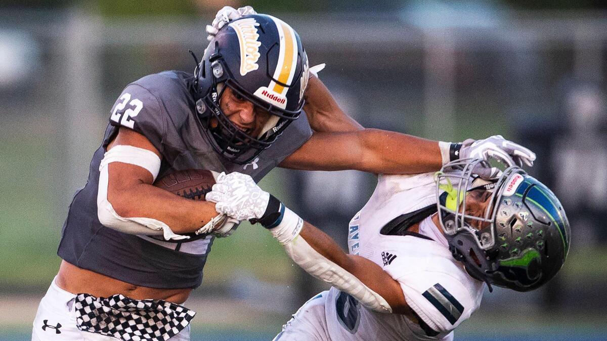 Meridian running back Rylie Byington stiff-arms Mountain View’s Mason Chiles on his way to a first down last season.