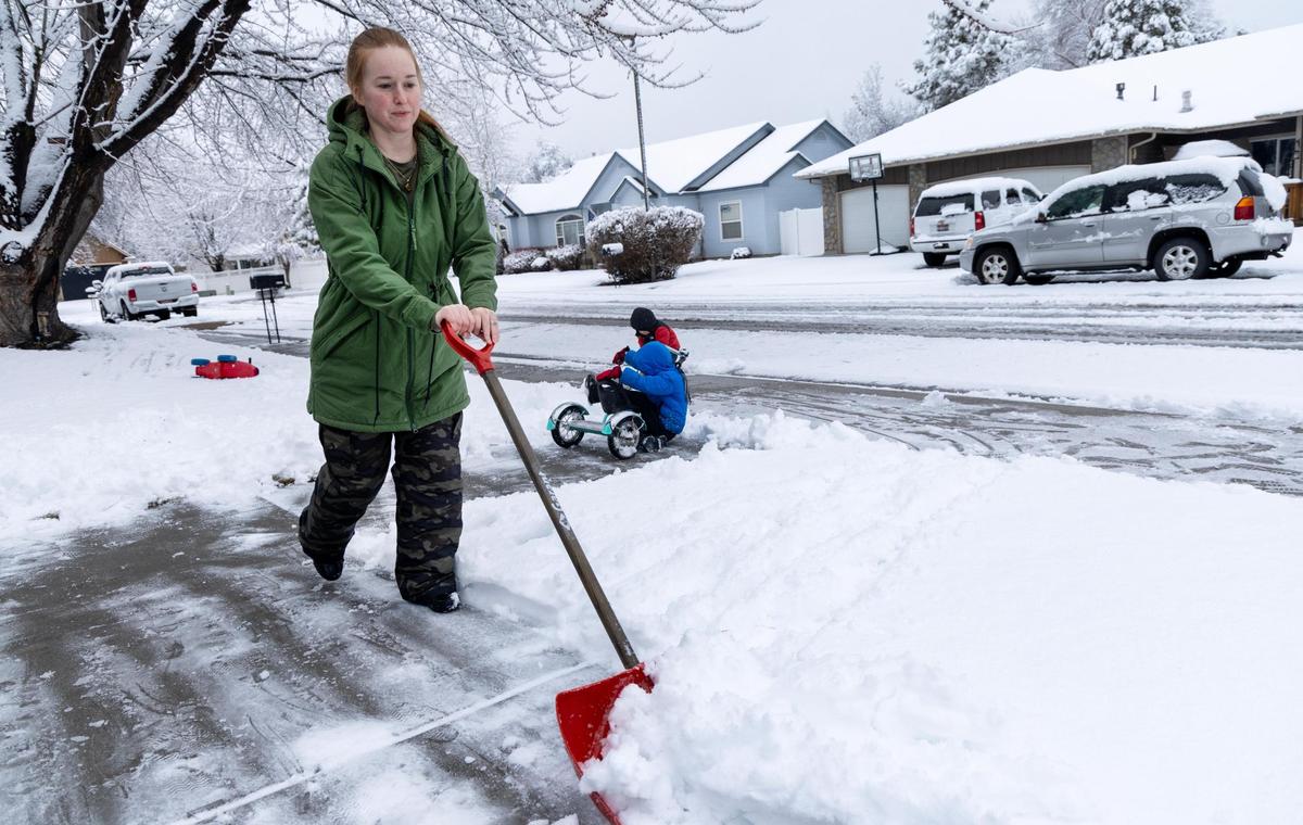 Rachael Bullock shovels snow from her driveway Friday in Meridian.