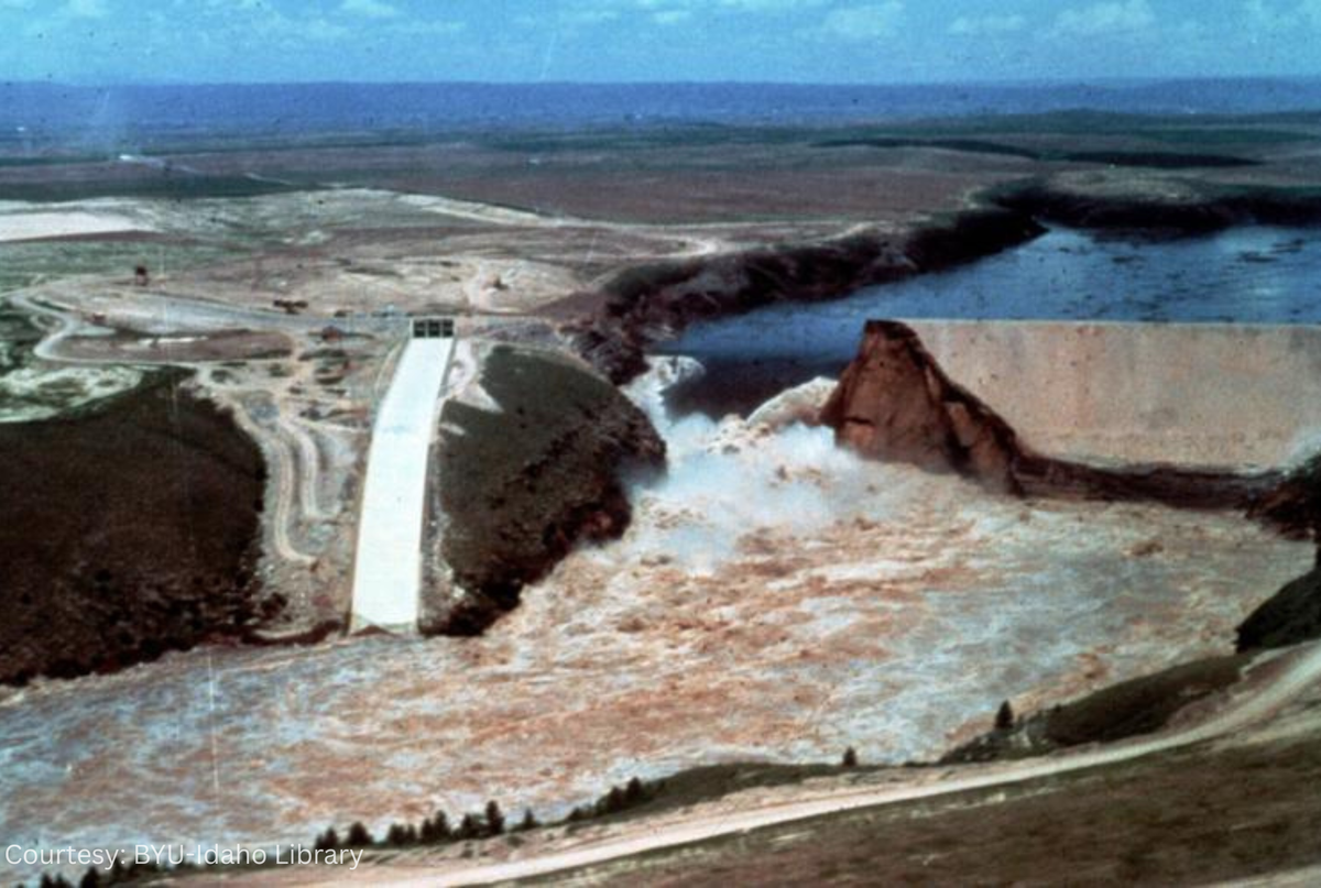 The chasm in the Teton Dam continued to widen as the pent-up water eroded the earthen structure. The 307-foot dam had been declared breached at 11:57 a.m. on June 5, 1976. The concrete structure to the left of the photo is the unused overflow spillway.