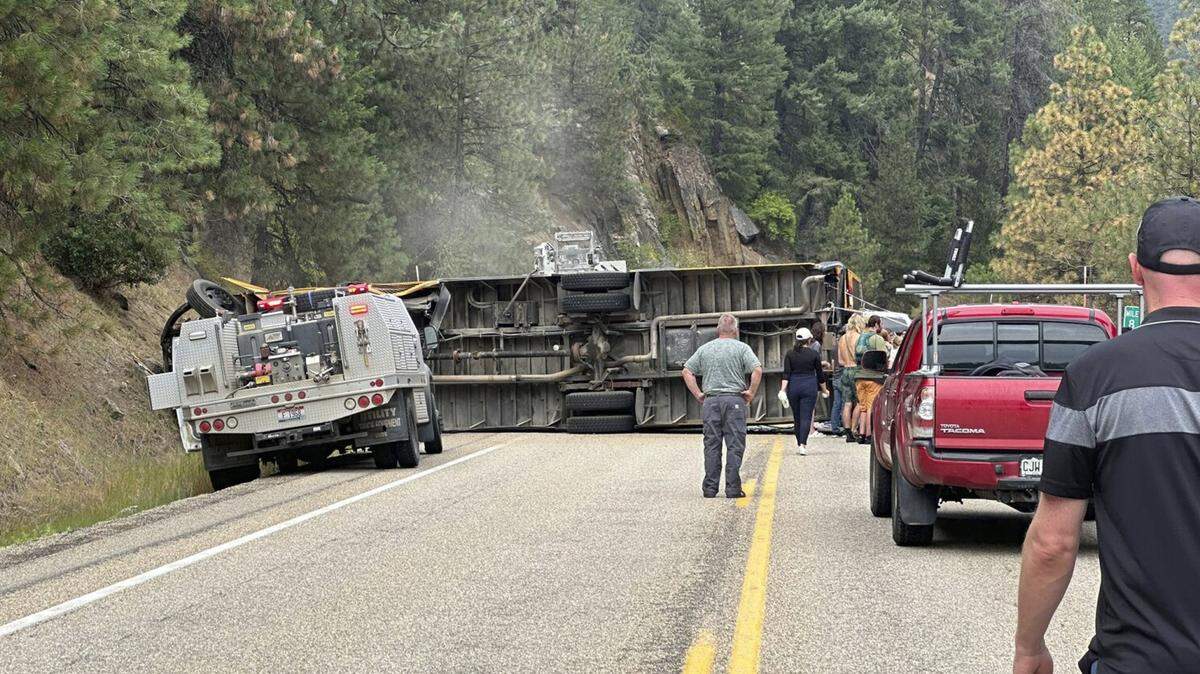 People respond after a bus overturned on Idaho 55 on Friday. The school bus was carrying teenage YMCA campers, several of whom were injured, Idaho State Police said.