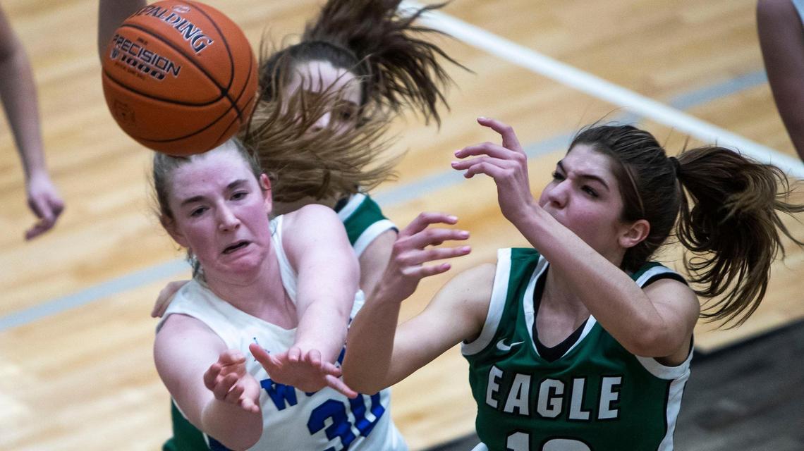 Eagle’s Paige Cofer, right, battles for a rebound with Timberline’s Aly Cox during the district semifinals last winter.