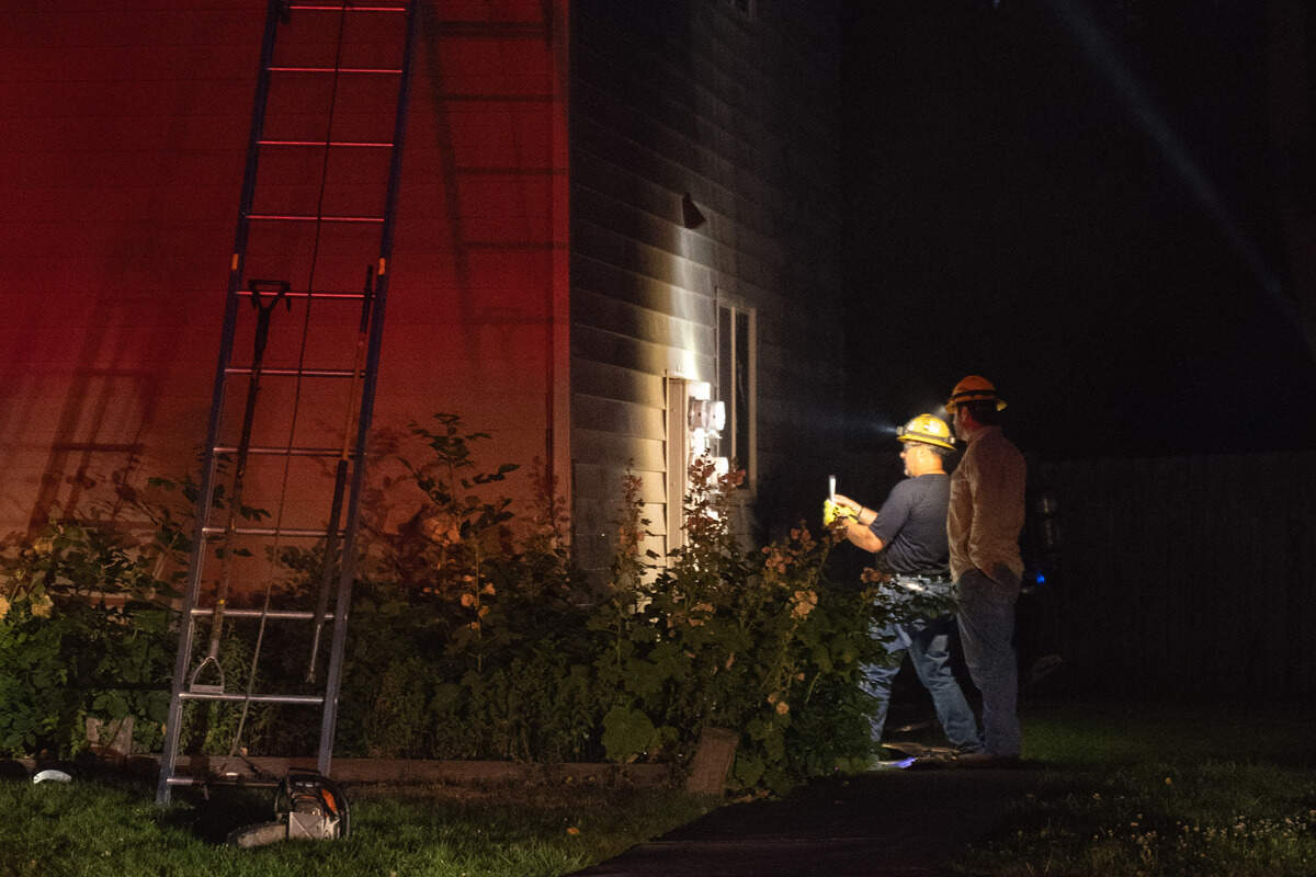 First responders inspect a circuit breaker outside the apartment that caught fire Tuesday in Southeast Boise.