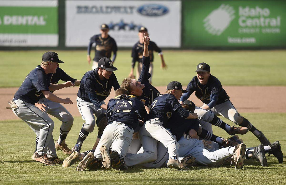Middleton players rush the pitcher after defeating Minico in the 4A baseball state championship Saturday at Melaleuca Field in Idaho Falls.