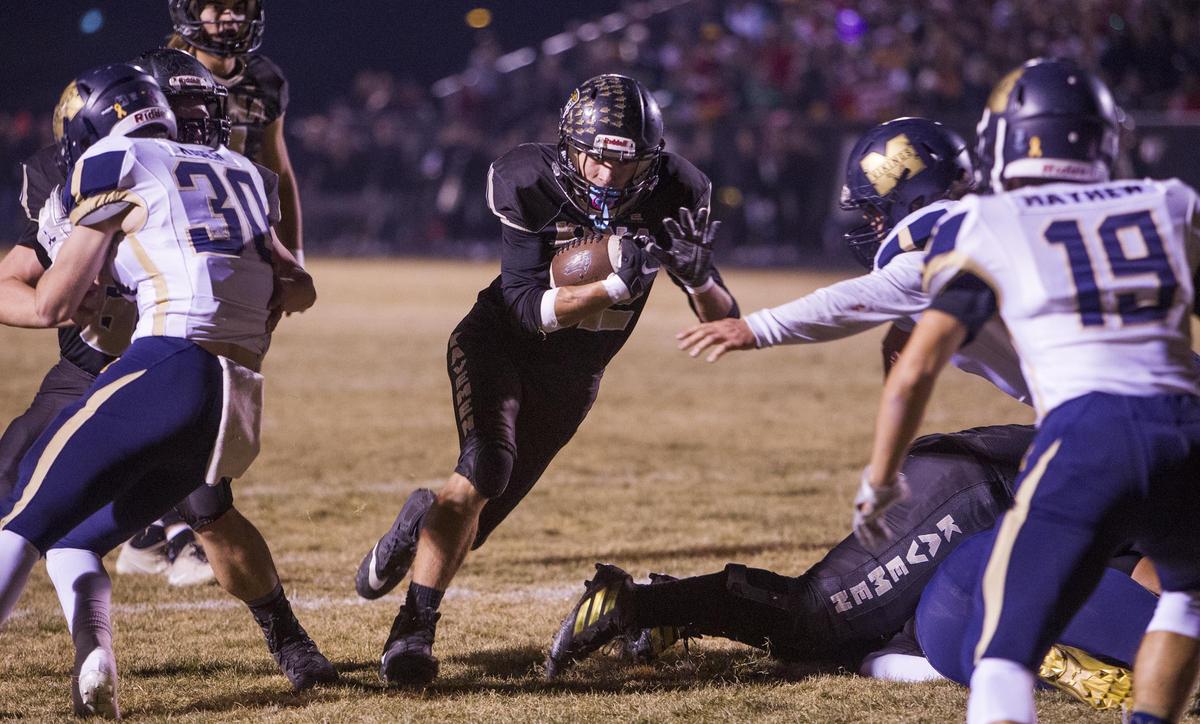 Kuna running back Jonathan Edwards finds a big hole in the Middleton defense for one of his four touchdowns in the 4A state semifinals last week.