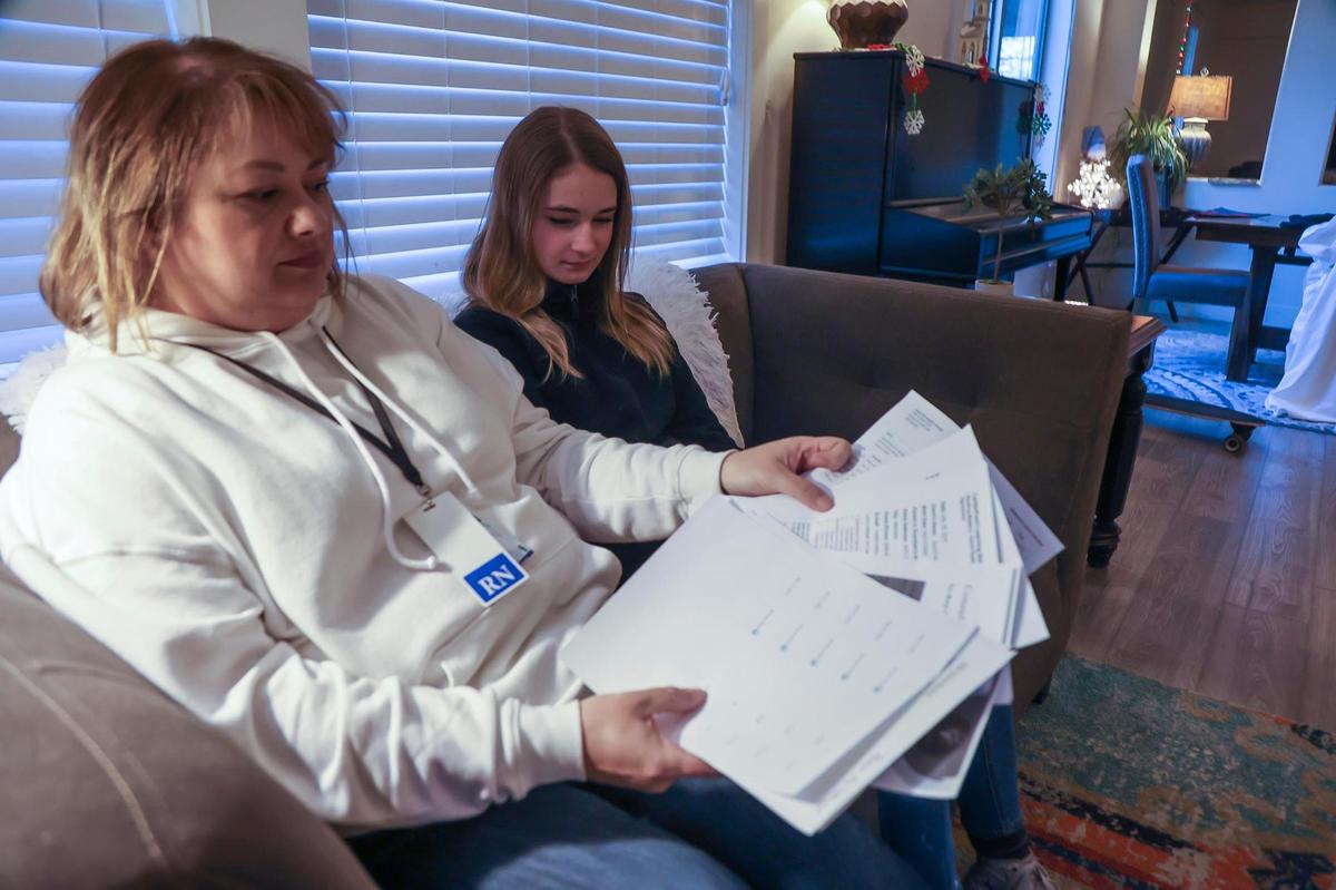 Quinn Nordick, 12, who was diagnosed with dyslexia, and her mother, Marji Nordick, in their Meridian home sift through the pages that showed the thousands of dollars the family incurred in out-of-pocket expenses when they sought learning interventions for Quinn, on Friday, Dec. 17, 2021.