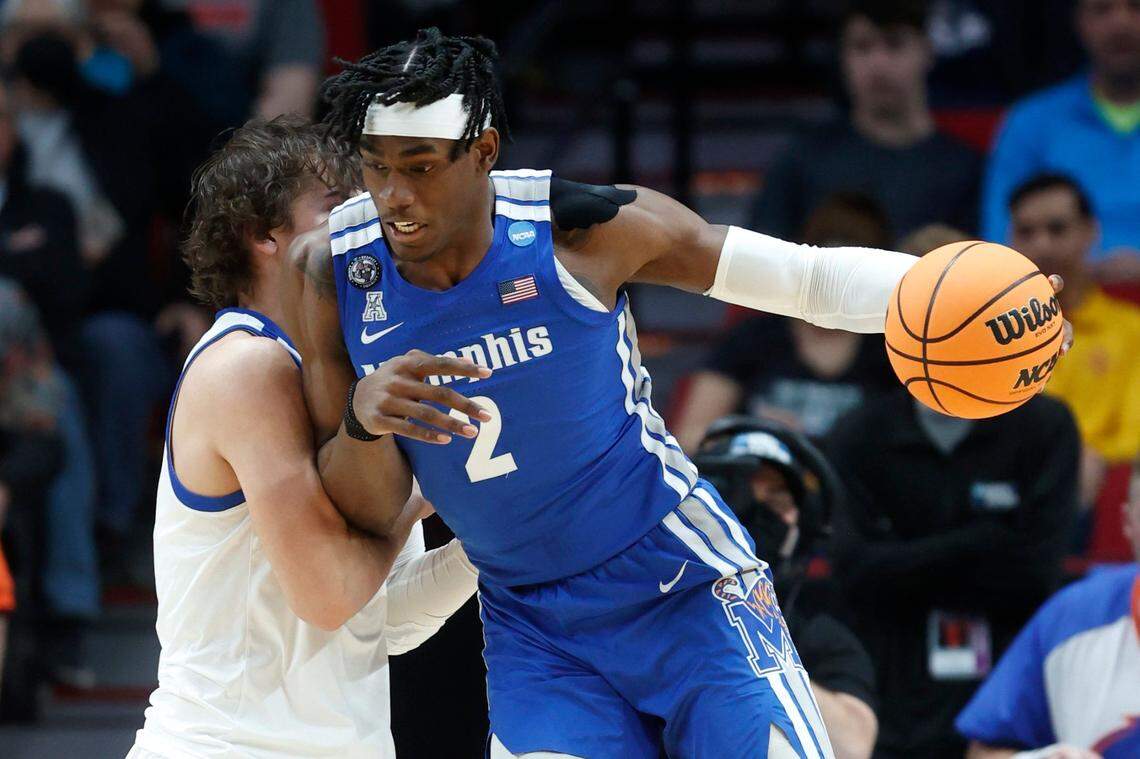 Memphis center Jalen Duren drives past Boise State forward Tyson Degenhart, left, during the first half of a first-round NCAA Tournament game Thursday in Portland.