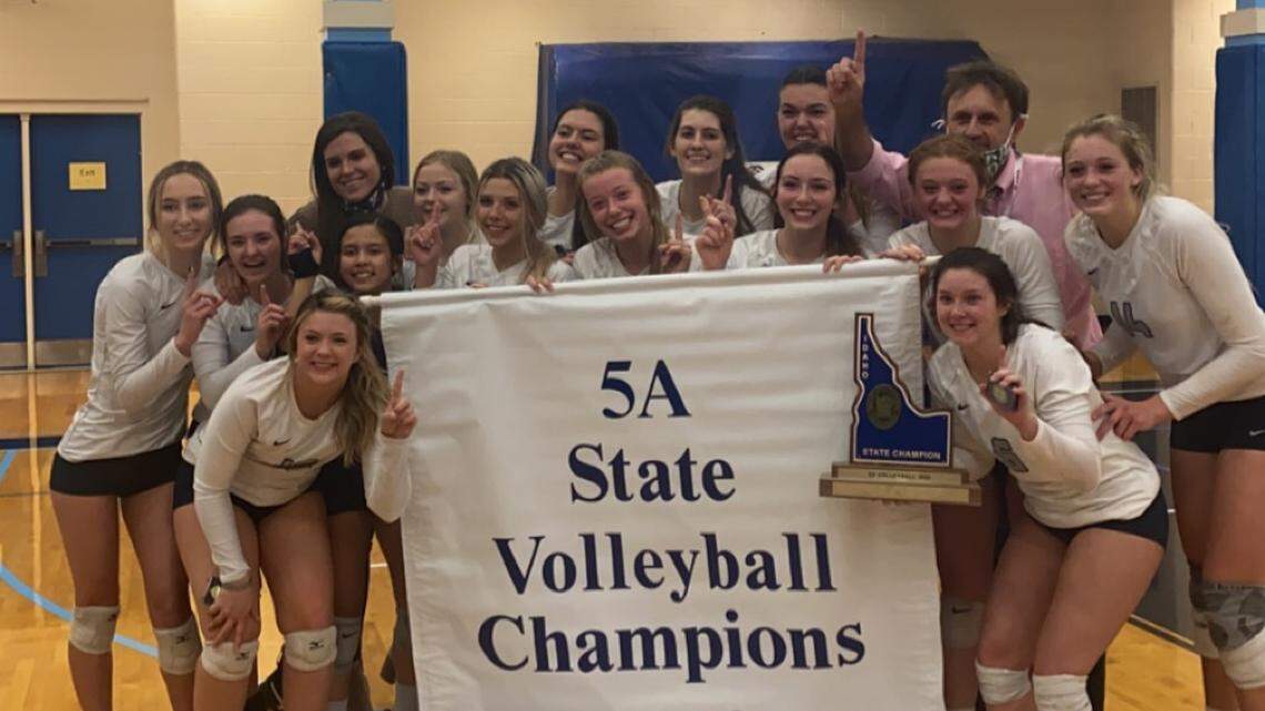The Skyview High volleyball team poses with the 5A championship banner after beating Boise in five sets Saturday in Idaho Falls.