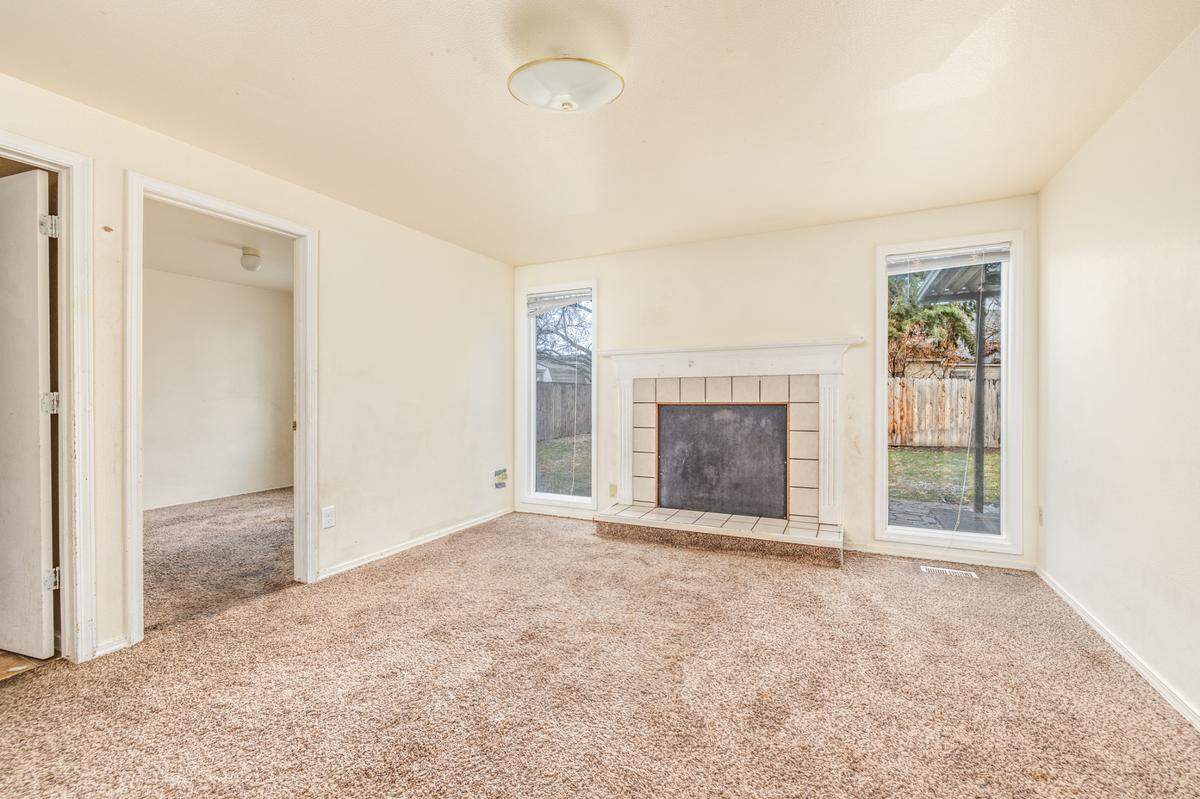 Most of the rooms in the Poppy Street home are carpeted, while the Woody Drive home have hardwood floors.