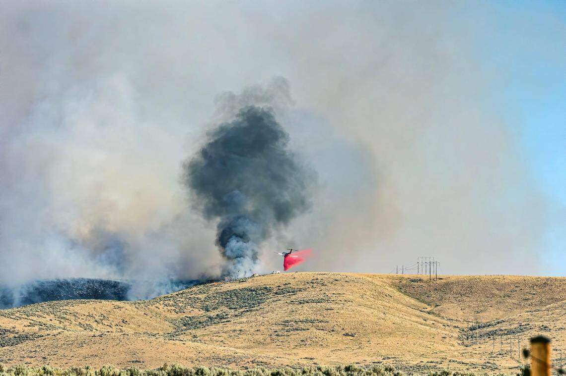 A 2021 photograph from Rachaelle Larsen-Grimsrud’s backyard in the Sunny Ridge subdivision in Southeast Boise shows fire crews fighting a blaze near her home.