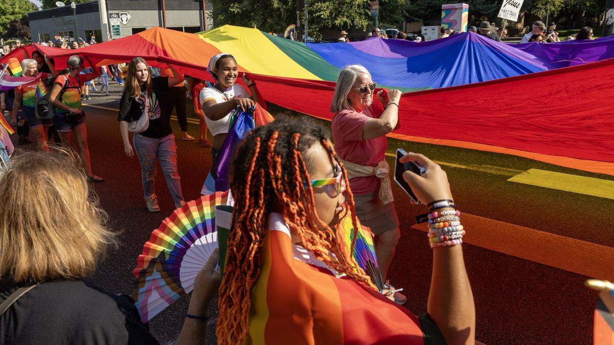 People carry a large rainbow flag as they participate in the Boise Pride parade along River Street, Sunday, Sept. 7, 2025.