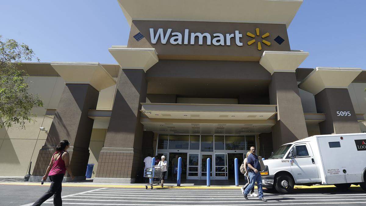 Customers walk outside of a Walmart store in San Jose, Calif.