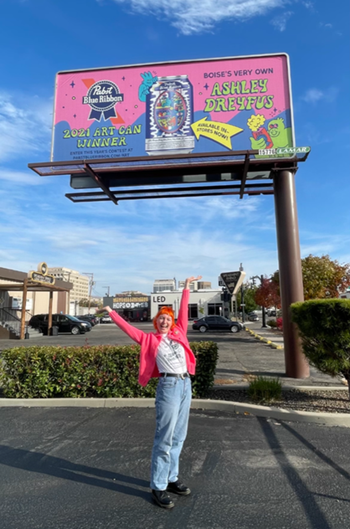 Boise artist Ashley Dreyfus poses in front of one of the six billboards in the Boise area highlighting her PBR cans.