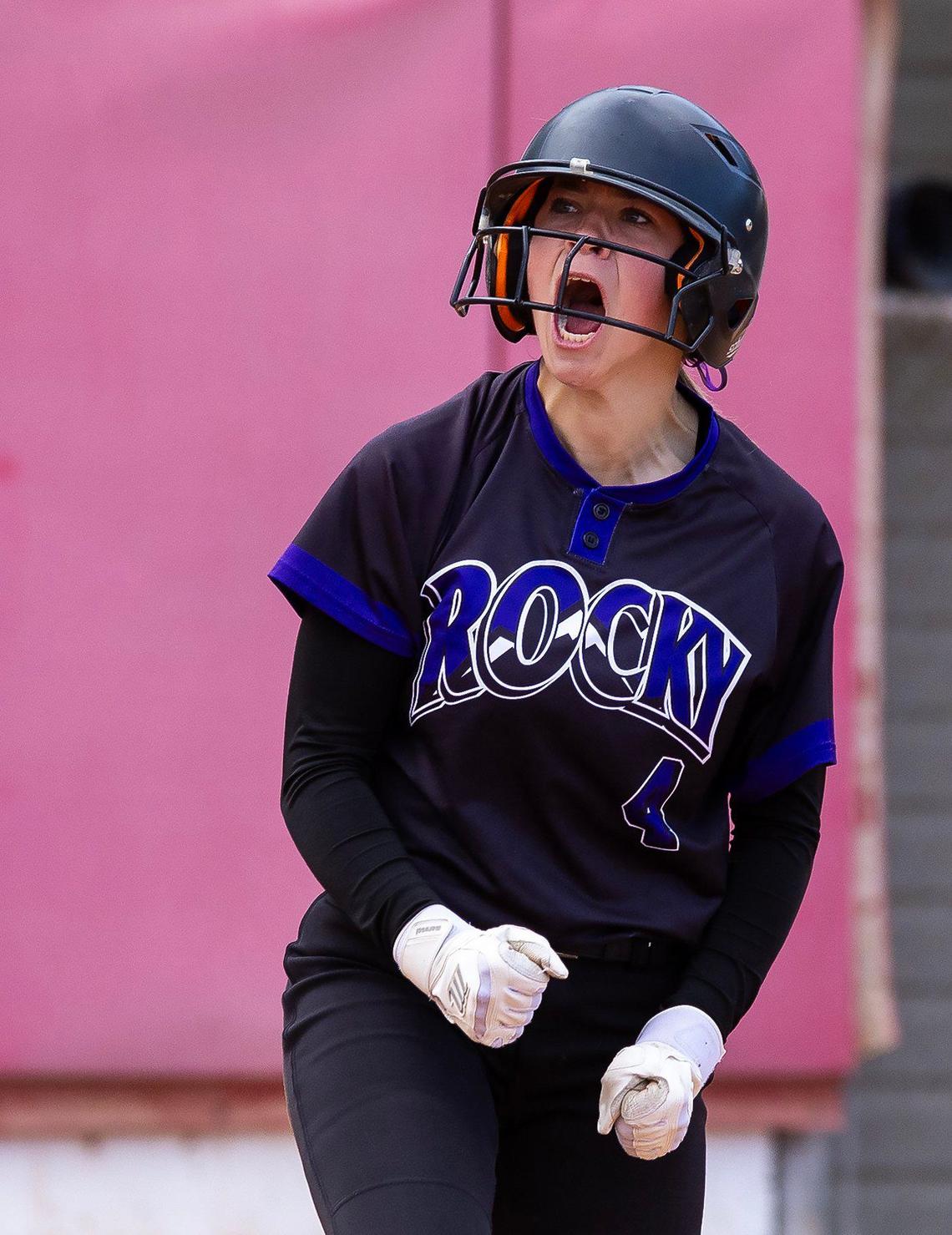 Rocky Mountain sophomore Tayler Klozcko reacts after sliding past Eagle catcher Emry Woods to home plate on Tuesday at Mountain Cove Field. The Grizzlies won 16-14 in nine innings.